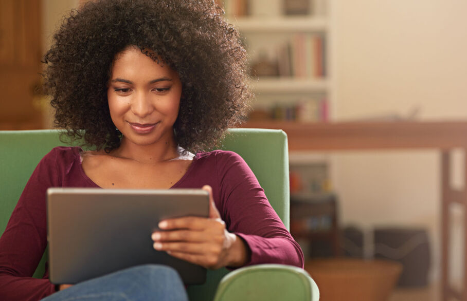 Person sat looking at a tablet computer