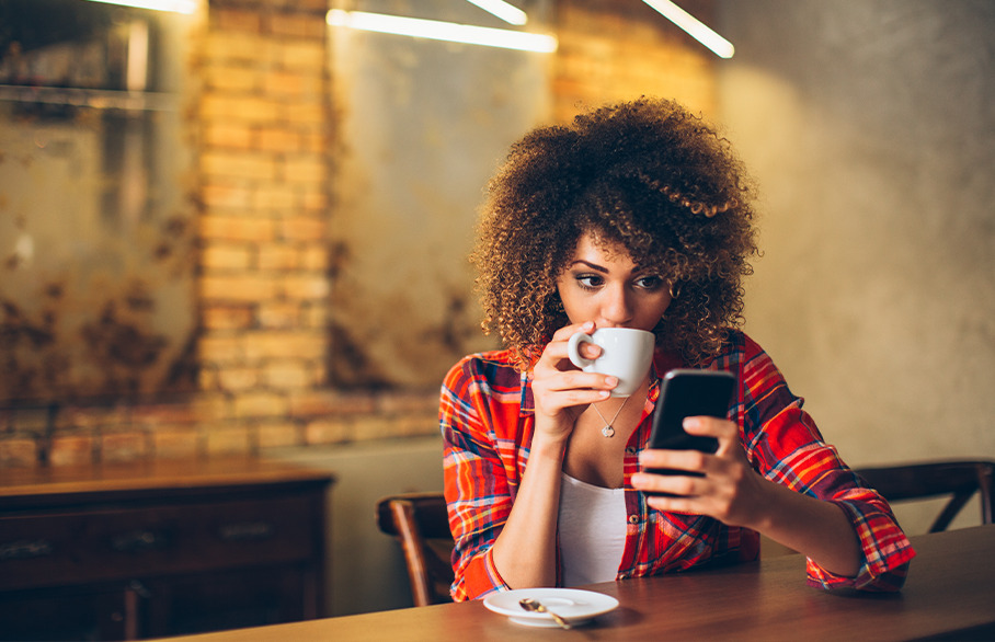 Woman on phone with coffee