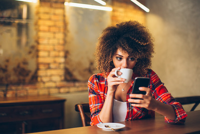 Woman on phone with coffee